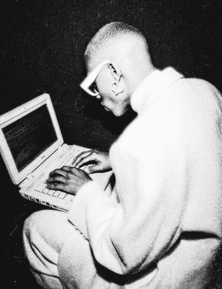 Black and white portrait of a person working on a laptop